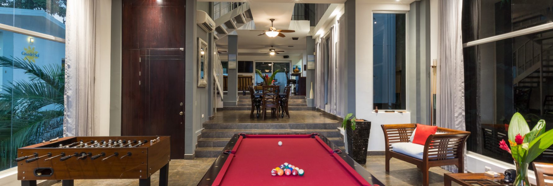 The game room features comfy seating, pool table, foosball table and breathtaking view of the rest of the house.