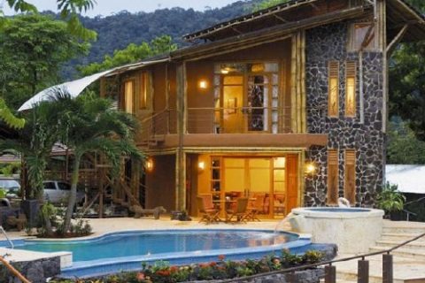 Private villa features stone walls, bamboo terraces and an infinity pool