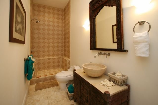 This guest bathroom features a beautifully-tiled shower and all the amenities you need.