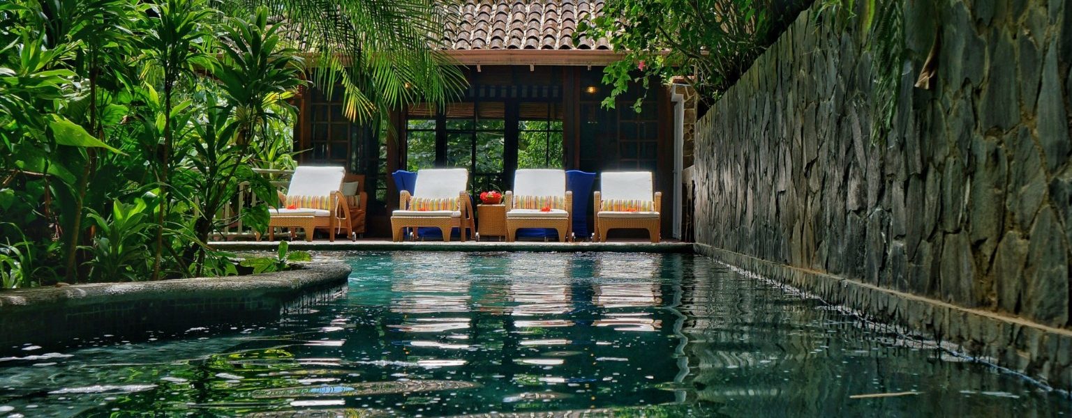 Take a refreshing dip in the pool, or relax in front of the pool house.