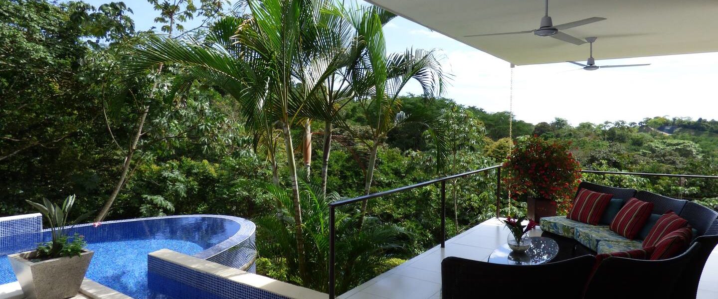 This beautiful balcony lounge area by the infinity pool enjoys stunning panoramic rainforest views.