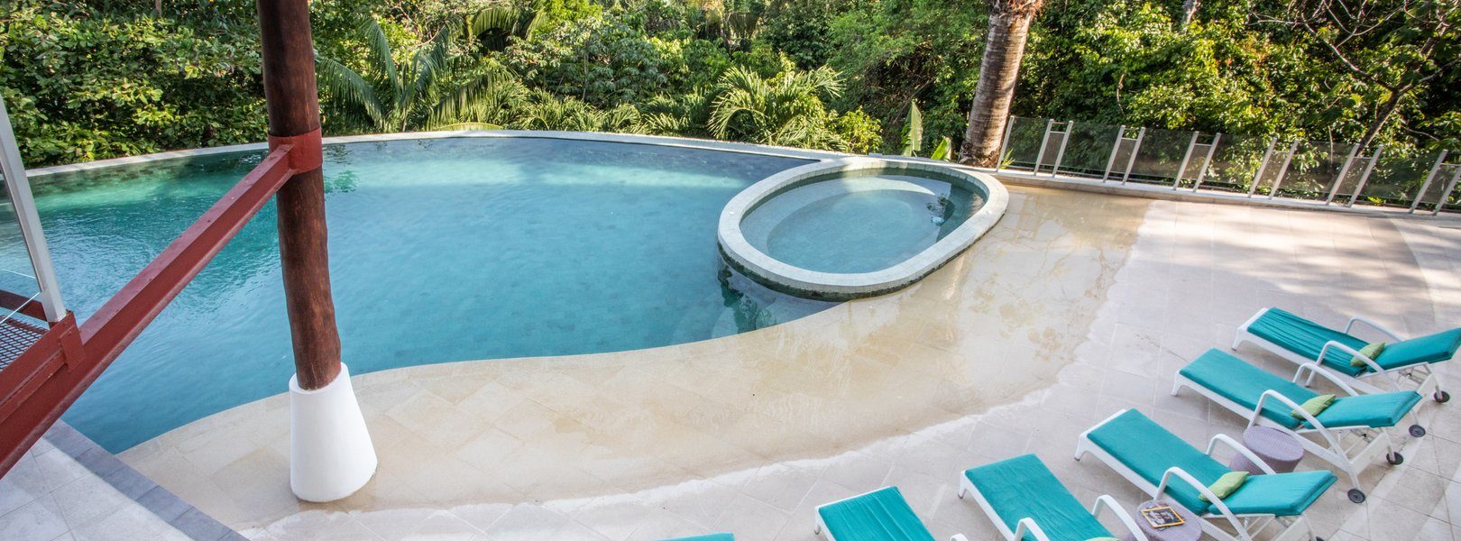 Lounge chairs surround parts of this truly awesome infinity pool, giving you time tortillas after a long days worth of vacationing.