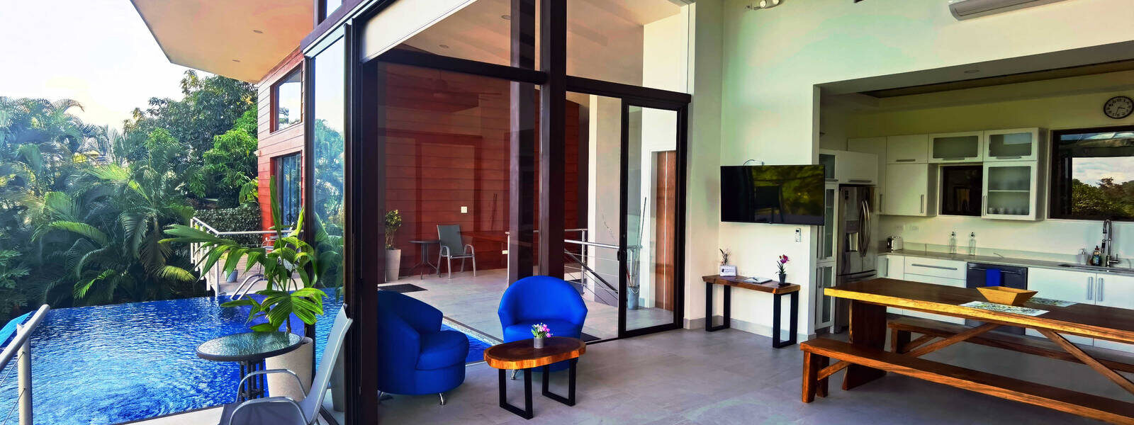 Huge sliding glass doors create an open-air living space where the outside is invited in.