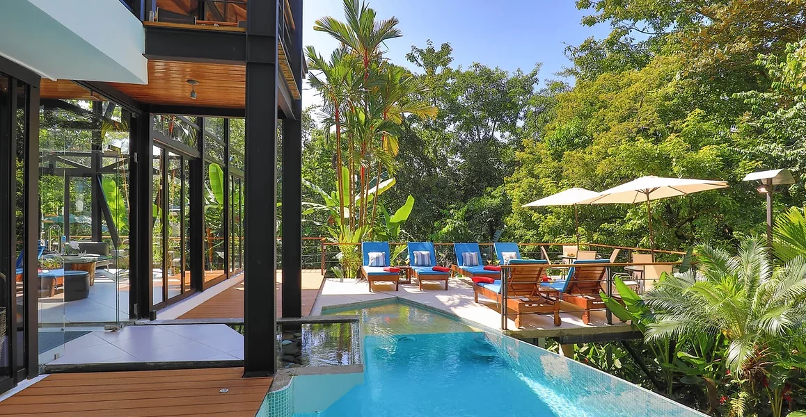 The breathtaking pool and deck area outside the villa provide a stylish spot to unwind and soak up the sun.